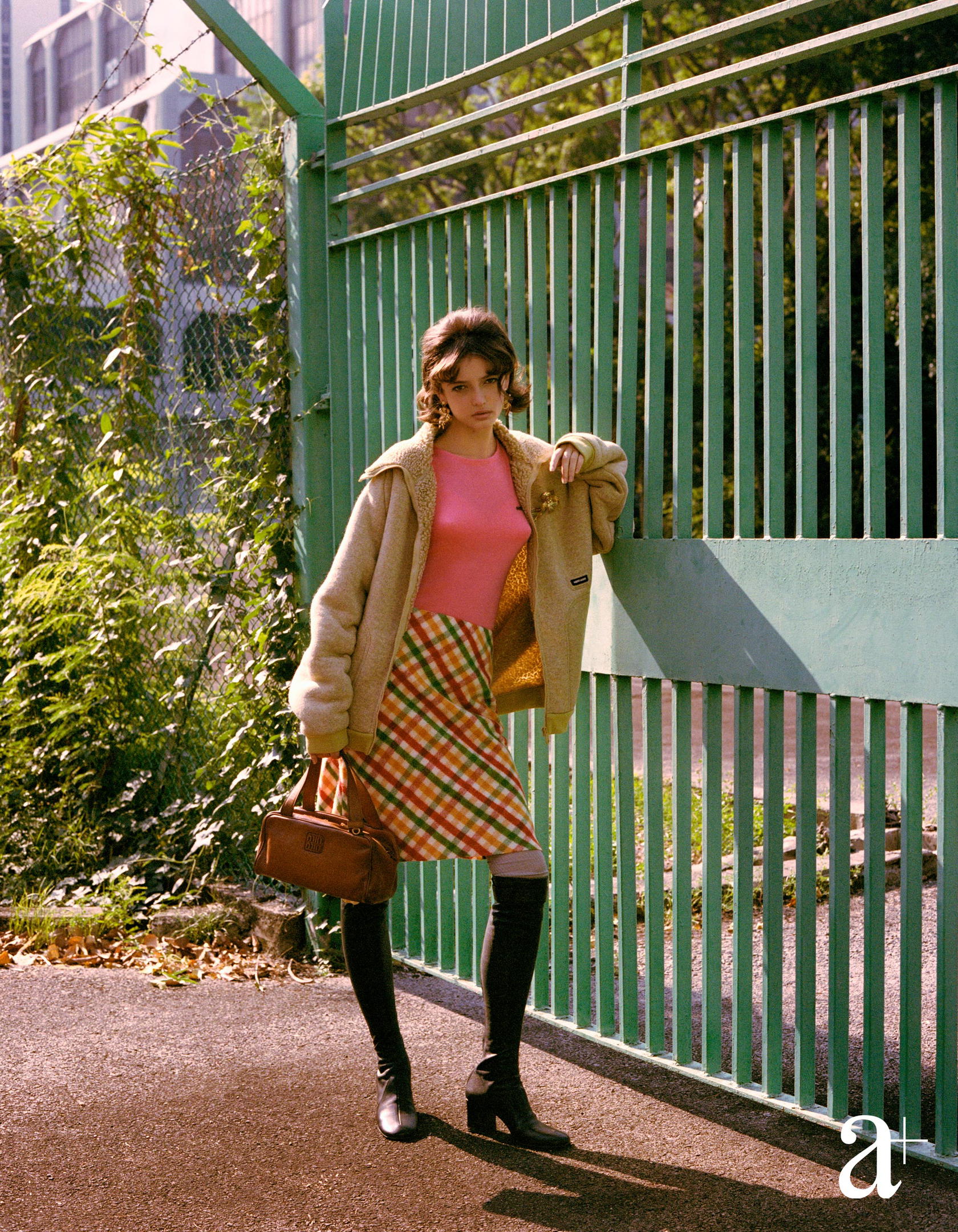 Cashmere and silk knit top, cotton fleece jacket, wool skirt, brass brooch and earrings, calfskin top-handle bag, cotton socks, and lambskin buckle boots, all from Miu Miu (Credit: Stefan Khoo)