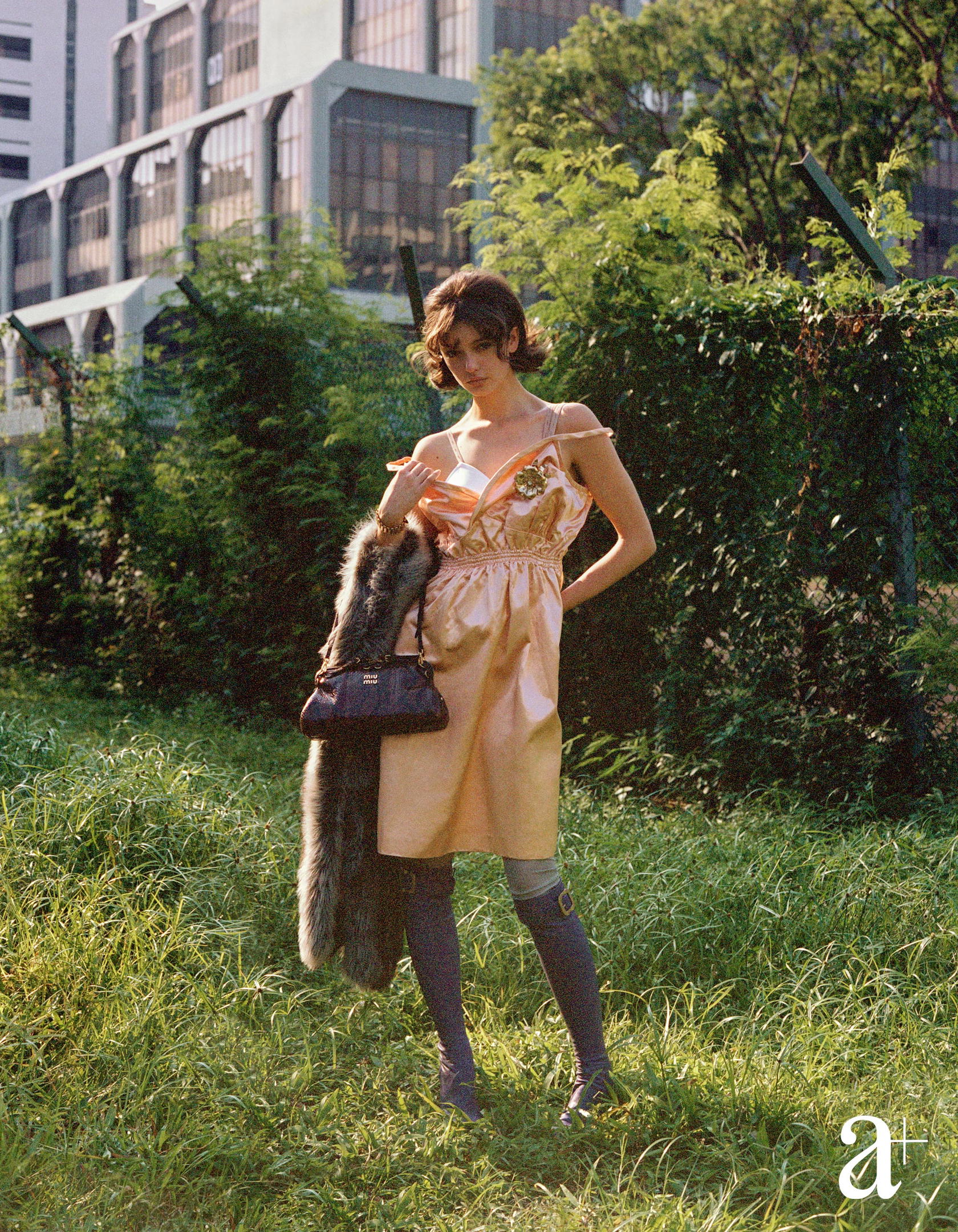 Silk satin bra and dress, shearling fur stole, python- printed Ayers water snakeskin bag, viscose socks, and lambskin buckle boots, all from Miu Miu (Credit: Stefan Khoo)