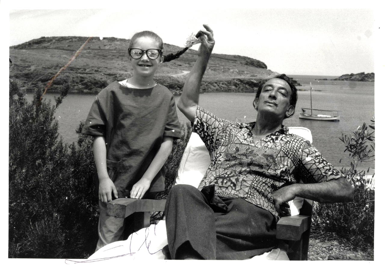 Argillet, 8, with Dalí in 1963, wearing multi-focus glasses he wanted her to try (Credit: Salvador Dalí: The Argillet Collection)