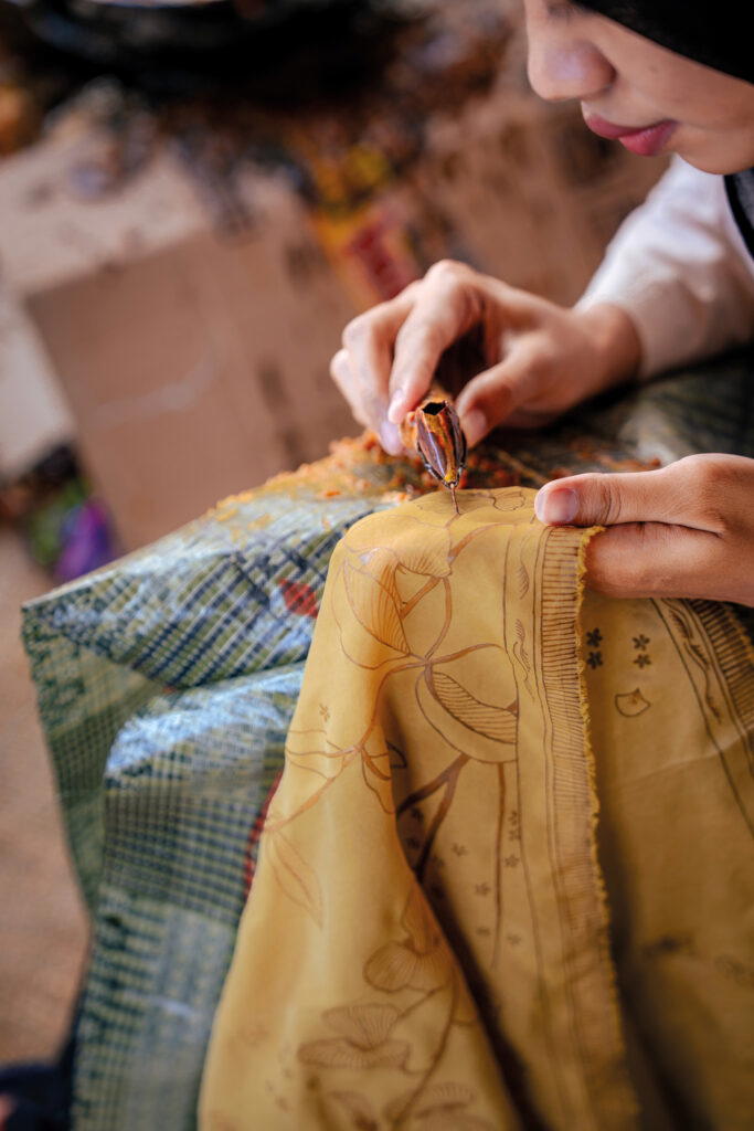 The process of creating batik involves drawing patterns on textiles with wax and a spouted tool called a canting (Credit: Rolex)