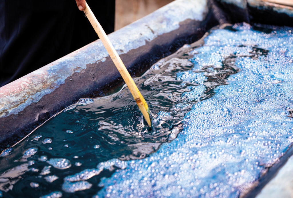SukkhaCitta uses only plant-based dyes, like this blue from fermenting indigo leaves. Through its use of natural dyes, it has prevented over three million litres of toxic chemicals from being dumped into Indonesian rivers (Credit: Rolex)
