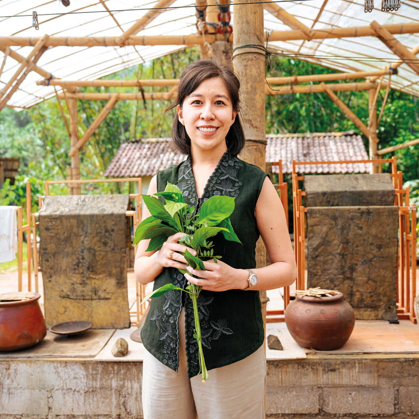 Riadini-Flesch carrying indigo leaves harvested in Central Java, Indonesia. Indigo dye is used to create some of SukkhaCitta’s high-quality, traditional clothes, making it a true farm-to-closet company (Credit: Rolex)