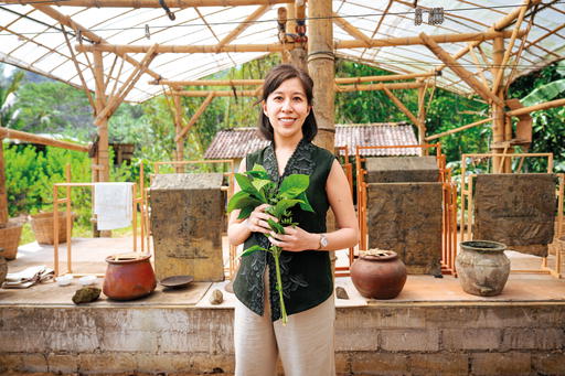 Riadini-Flesch carrying indigo leaves harvested in Central Java, Indonesia. Indigo dye is used to create some of SukkhaCitta’s high-quality, traditional clothes, making it a true farm-to-closet company (Credit: Rolex )