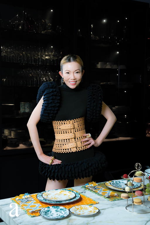 Wong poses with her vibrantly coloured Gucci Herbarium tableware (Credit: Yvonne Isabelle Ling )