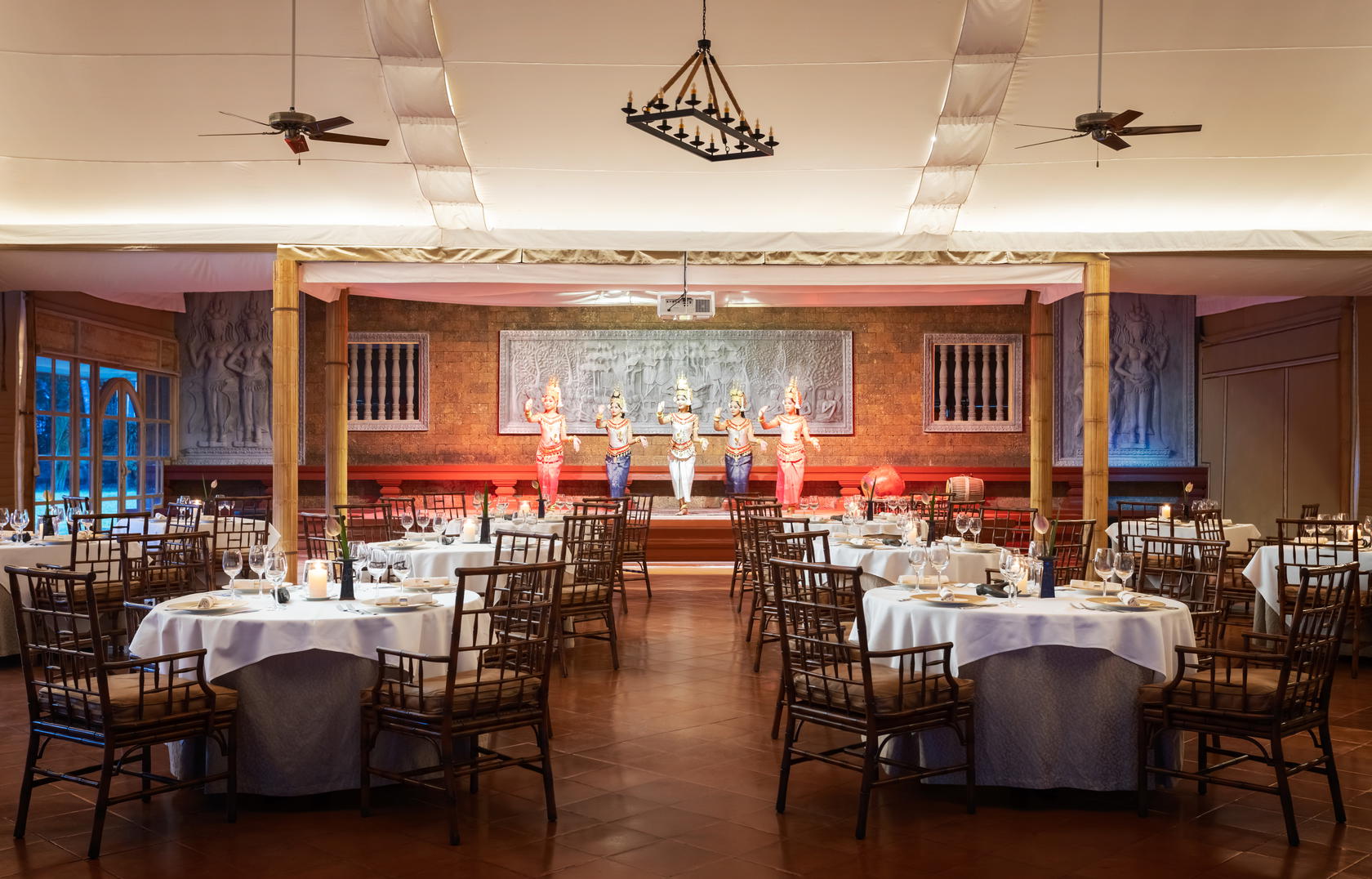The scene is set at the Raffles Marquee where guests are entertained by Apsara dancers and served Royal Khmer Cuisine (Credit: Raffles)
