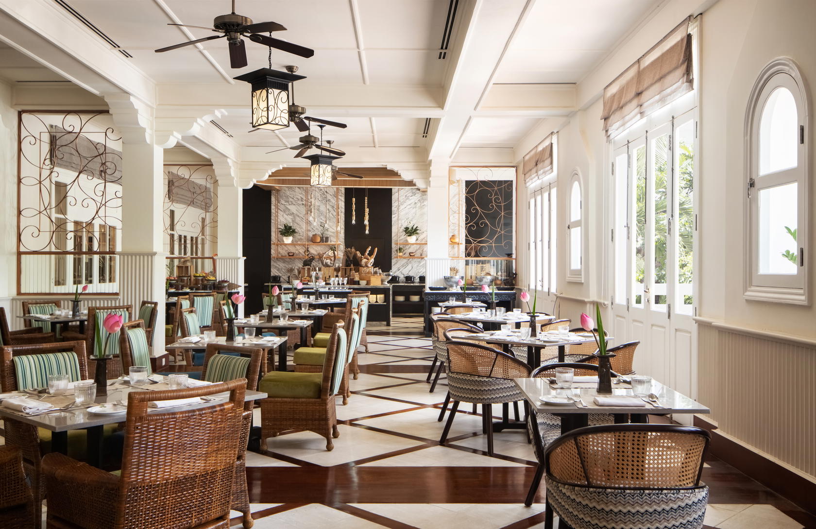 The light-filled dining room at Café d’Angkor, home to its signature Champagne breakfast. The brasserie-style restaurant serves international and local favourites throughout the day (Credit: Raffles)