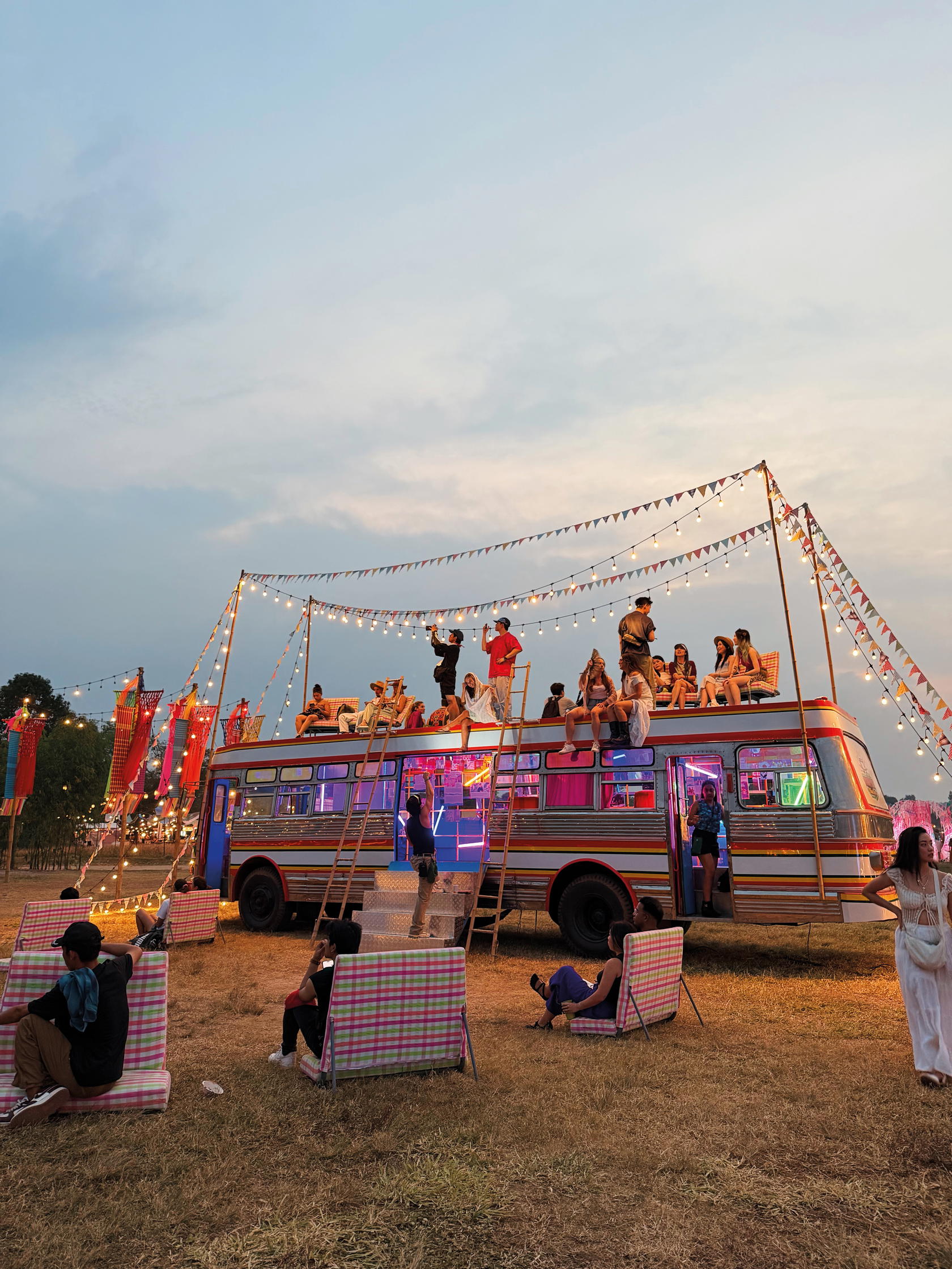 Relaxing to Northeastern Thai folk music on the Molam Stage’s iconic vintage bus (Credit: Samantha Francis)