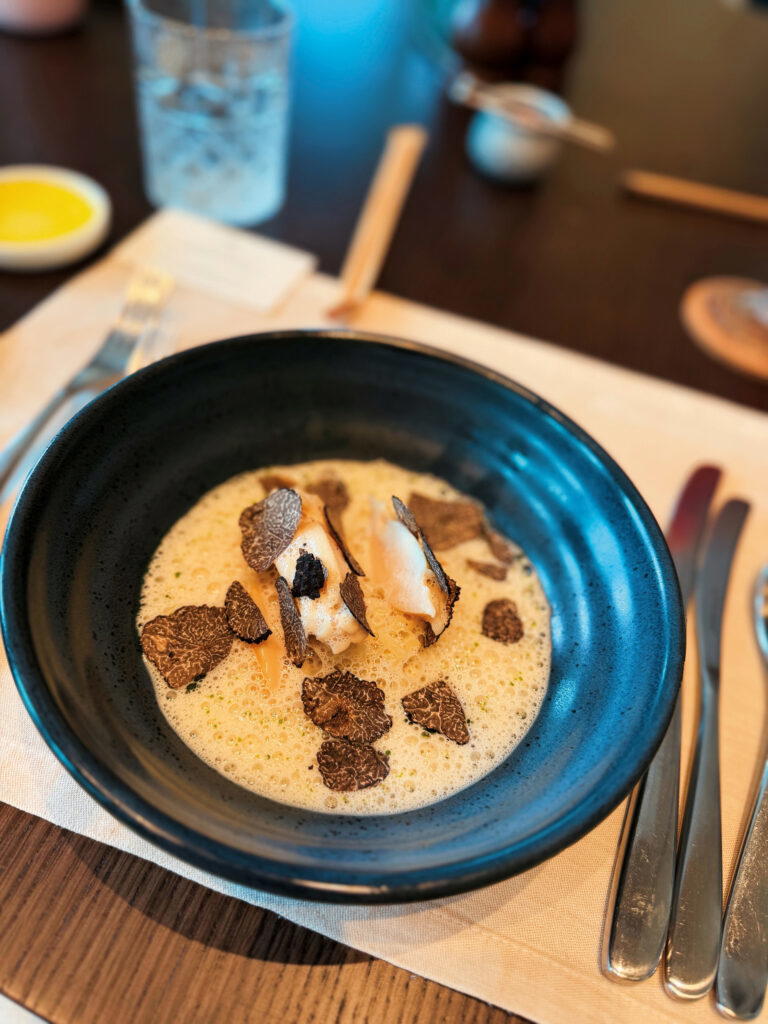 Hokkaido Abalone is served with dried porcini mushrooms, truffle shavings, cheese sauce, and acquerello rice (Credit: Samantha Francis)