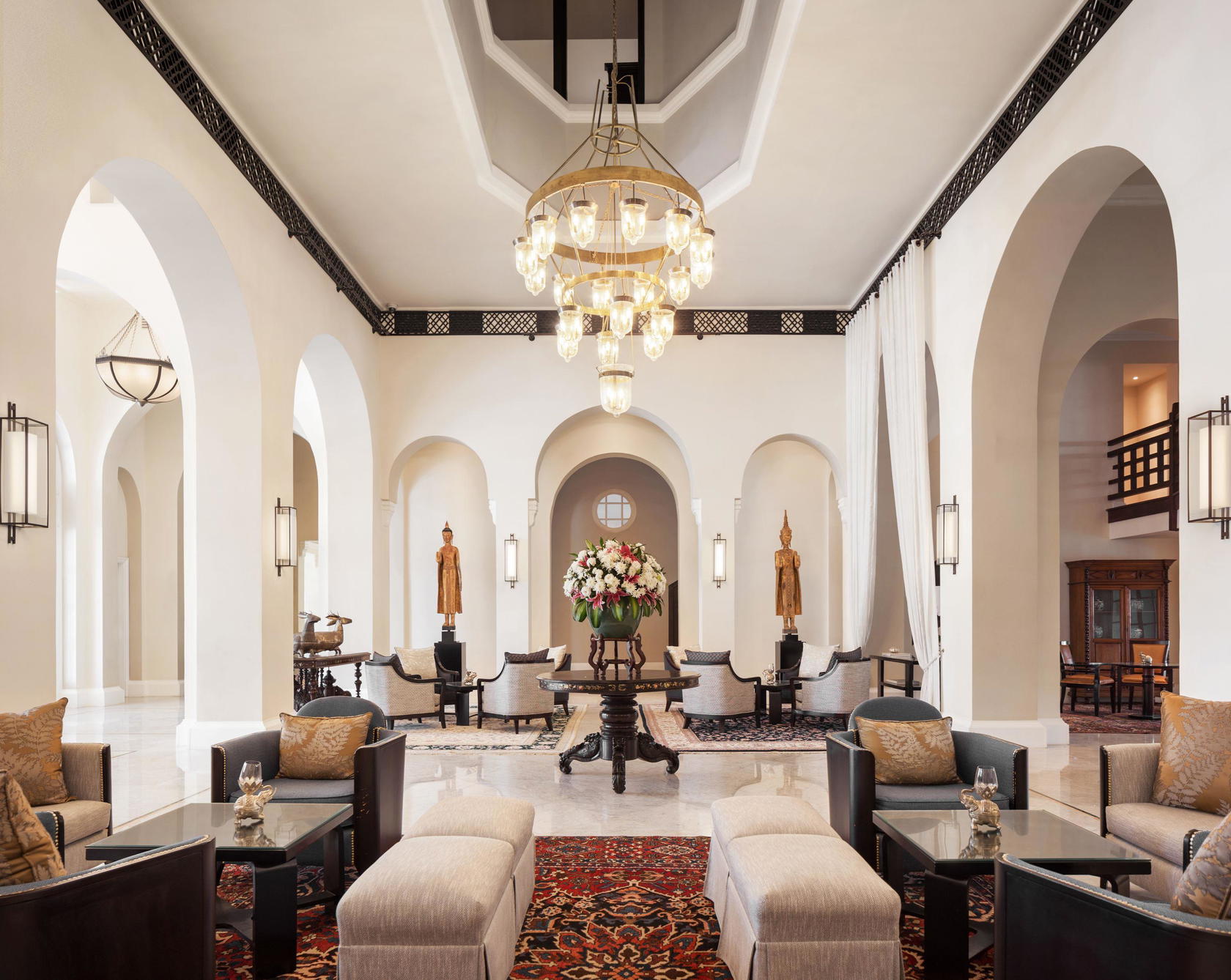 Soaring ceilings and graceful colonial arches define the main lobby at Raffles Hotel Le Royal Phnom Penh, where fresh flowers and plush accents provide the final touches (Credit: Raffles)