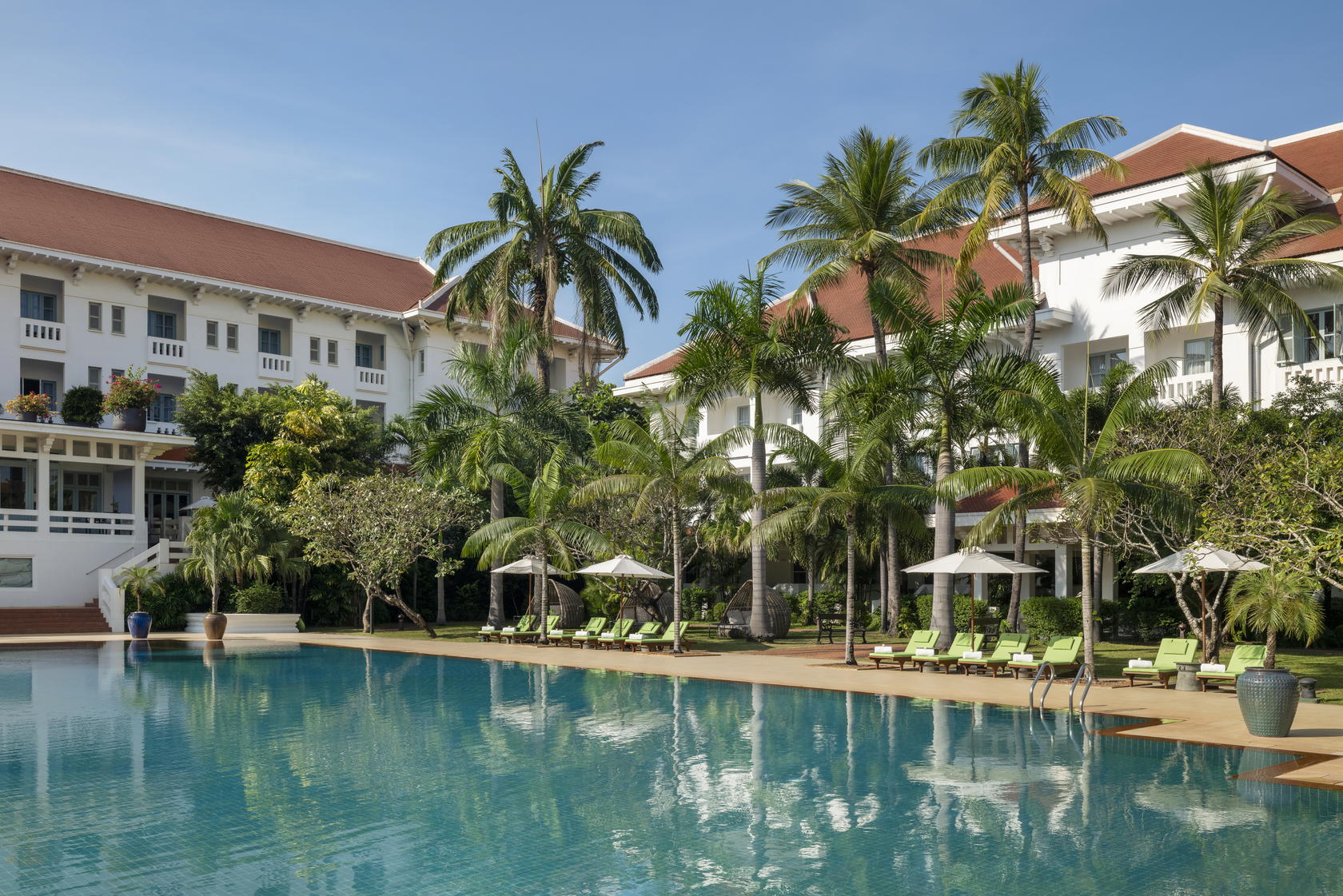 At Raffles Grand Hotel d’Angkor, the pool invites unhurried afternoons—spent reading, swimming, or lingering a little longer (Credit: Raffles)