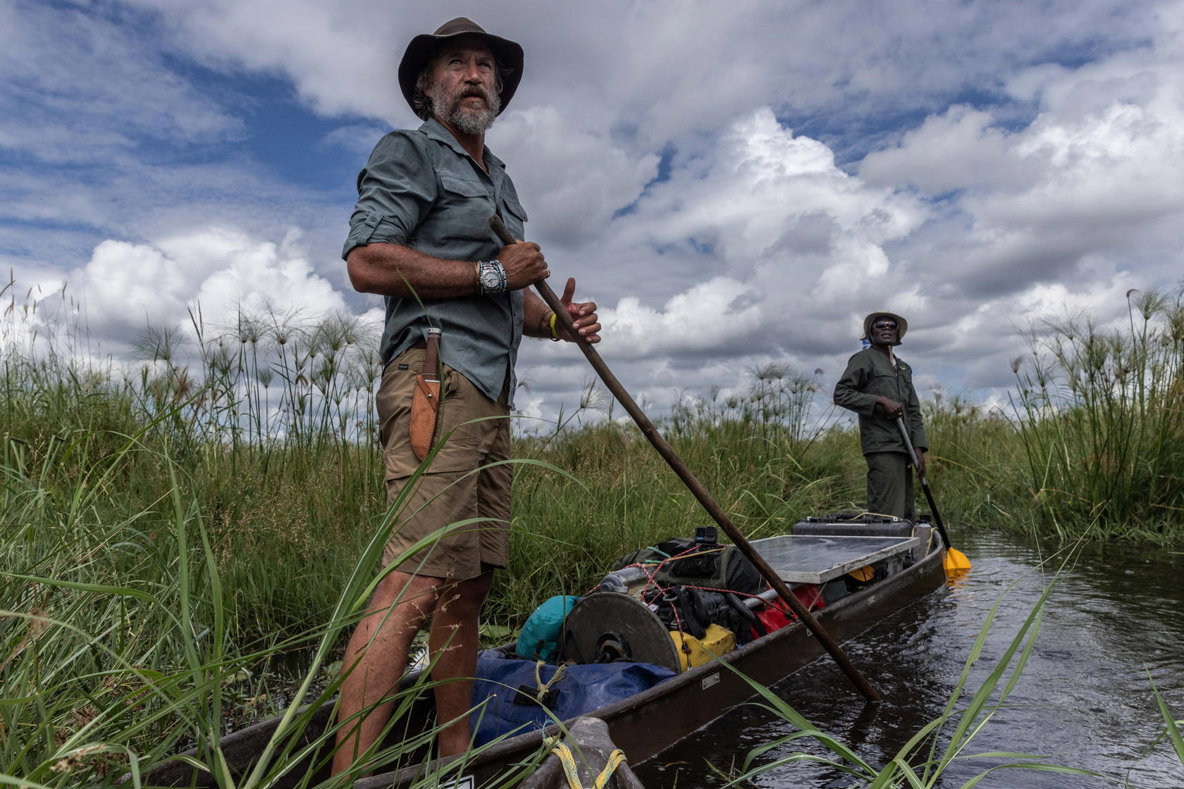 With expedition team member Gobonamang Kgetho, Boyes navigates the tall reeds and marshy conditions of the Kwando River in Botswana. Despite malaria and cancer, he continues to carry out critical research (Credit: The Wilderness Project/James Kydd)