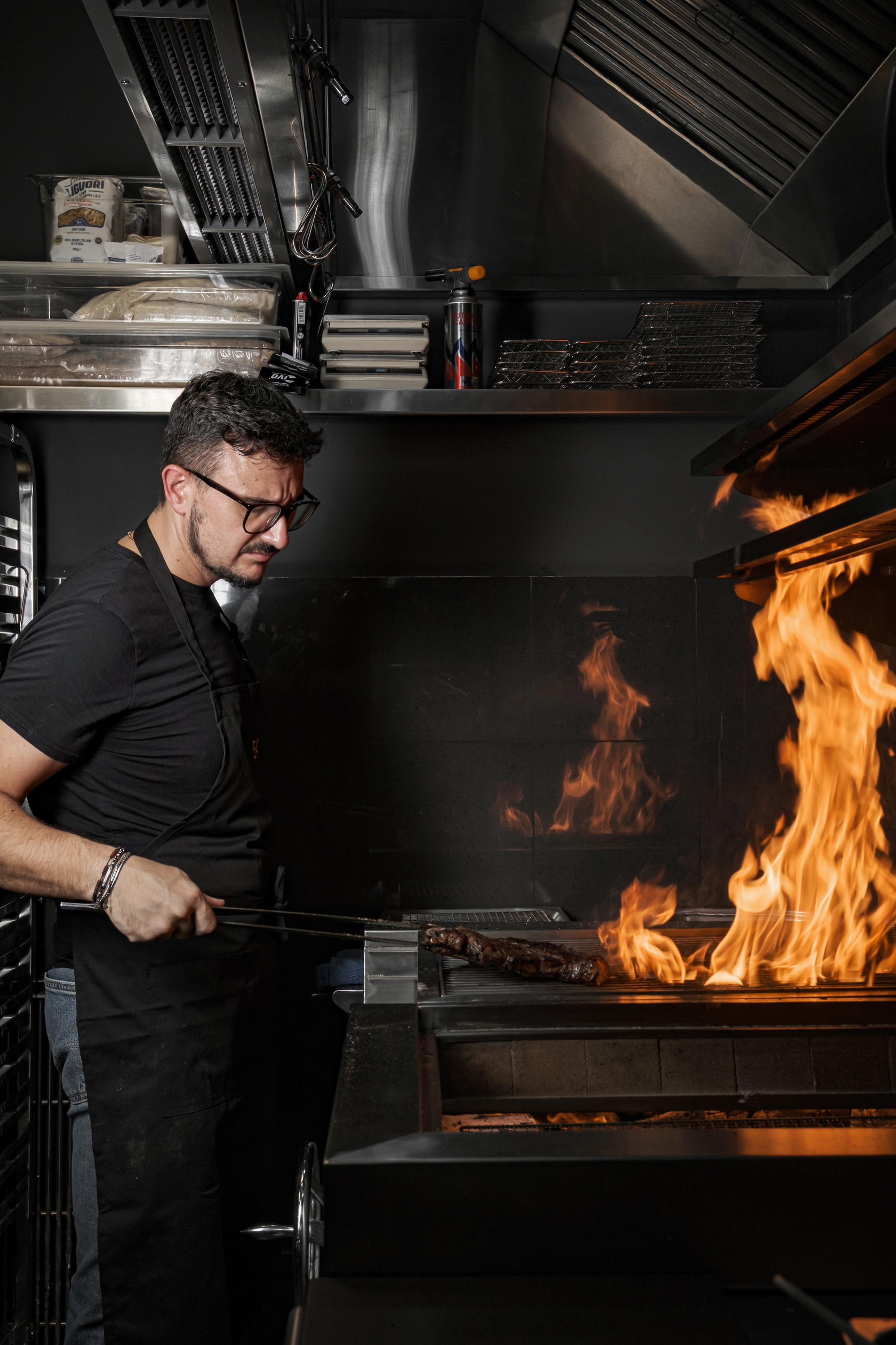 The restaurant employs a hybrid wood-fire technique that combines the dense, slow-burning heat of ironbark with the smokeless, ultra-hot finish of white binchotan (Credit: 54° Steakhouse Singapore)