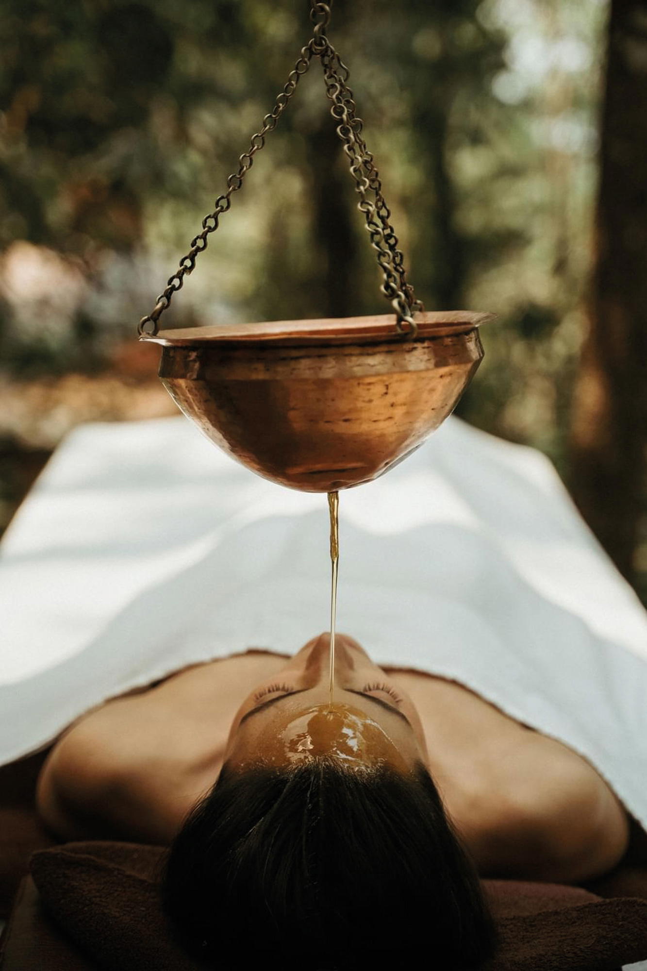 Ayurvedic Shirodhara therapy involves pouring warm herbal oils onto the forehead to induce deep relaxation (Credit: Charlotte Travel)