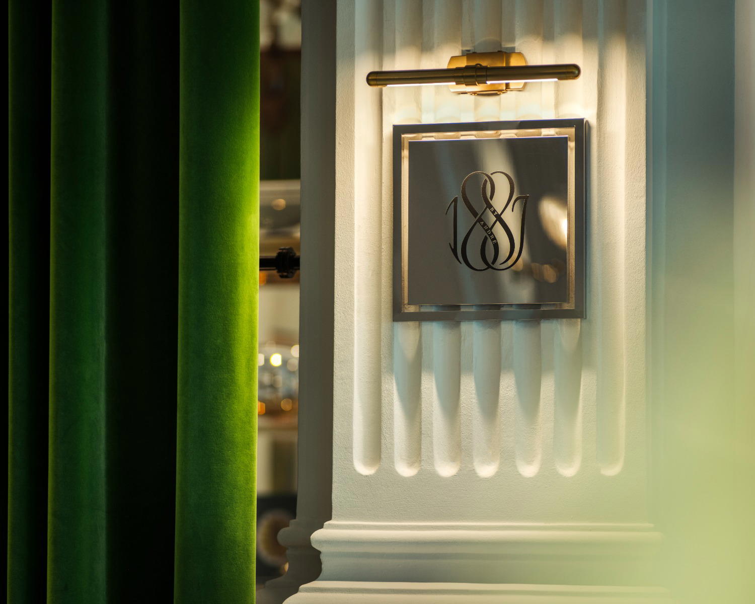 Designed by renowned architect and designer Bill Bensley, 1887 by André reimagines the century-old formal dining room of Raffles Hotel Singapore as an immersive space inspired by tropical glasshouses and the hotel’s architecture (Credit: 1887 By André)