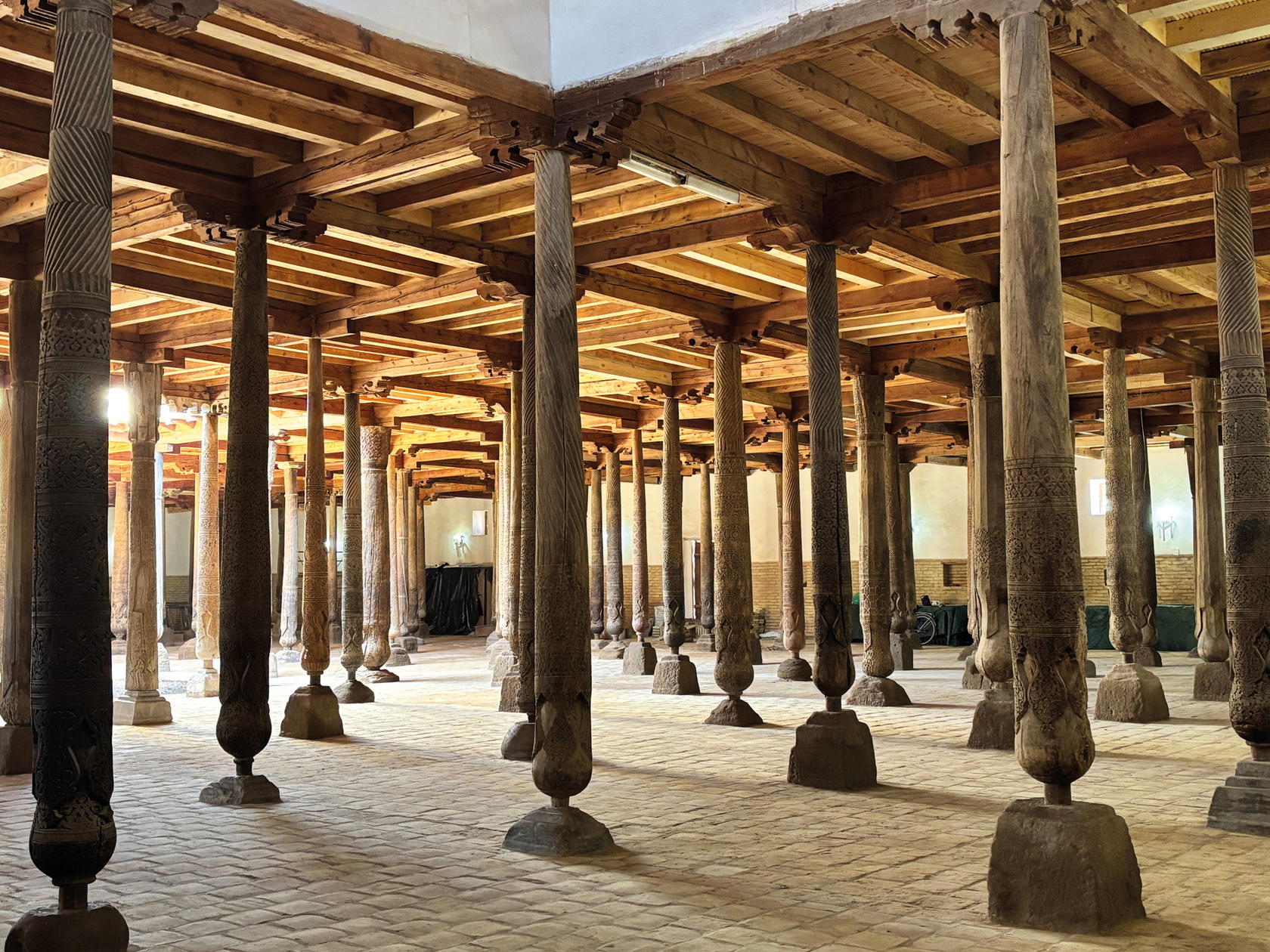 Ancient carved wooden pillars inside the Juma Mosque (Credit: Kalpana Sundar)