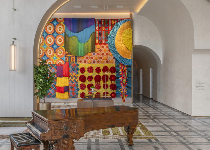 Ploenchan (Mook) Vinyaratn’s vibrant, hand-tufted carpet mural, which hangs in the guest lobby, reflects the hotel’s dynamic energy (Credit: Andaz)
