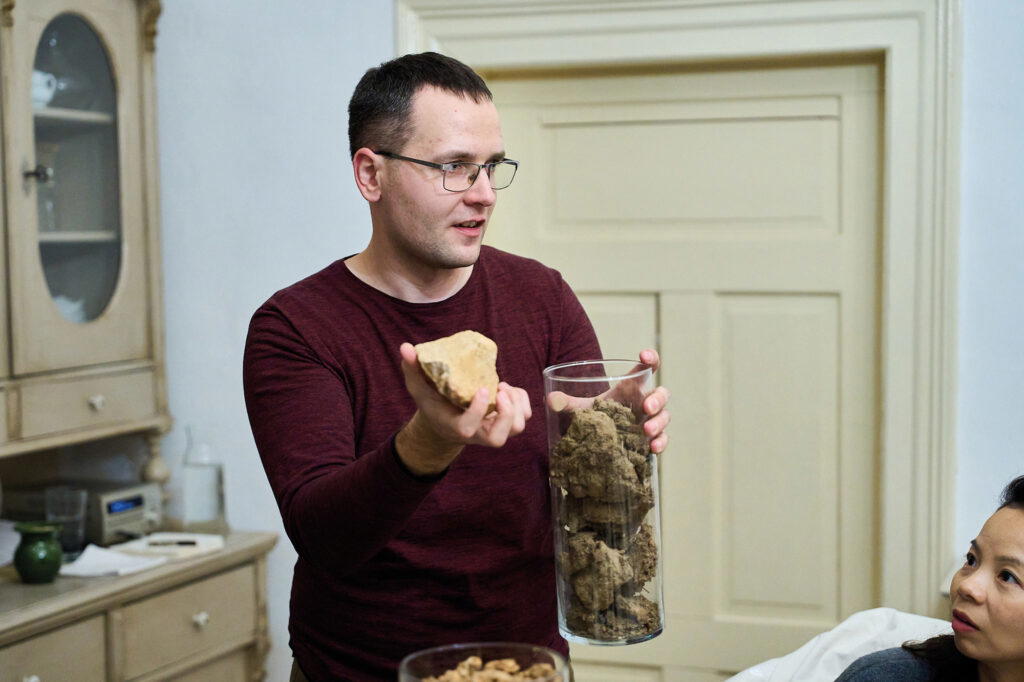 Ádám Tóth of Barta Pince shows off the rocks in their Tokaj vineyards (Credit: Wines of Hungary)