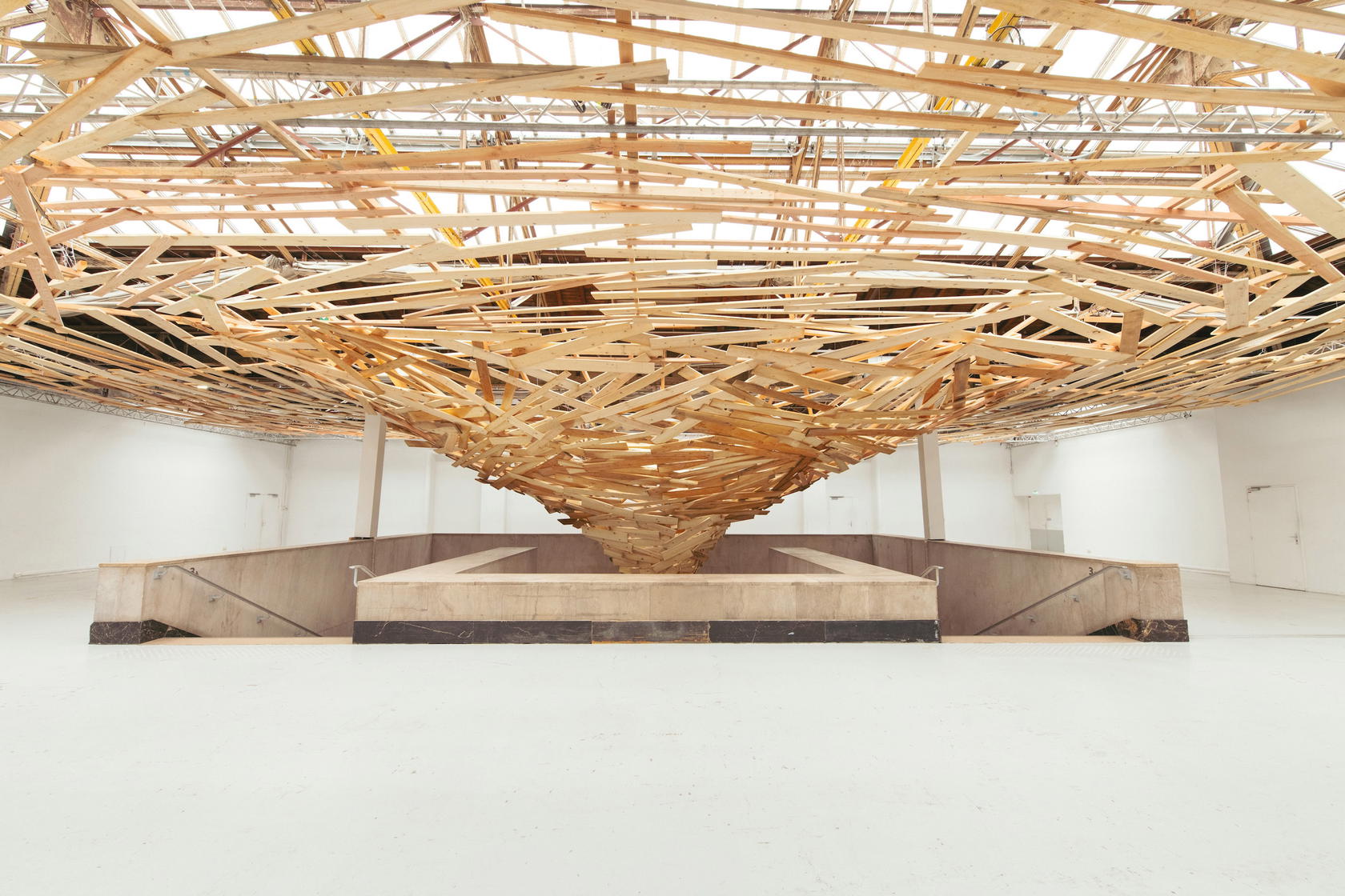 ‘Tornado’ 2026, exhibited at the Palais de Tokyo in Paris with support from Ruinart, depicts nature’s delicate balance within the champagne ecosystem. It includes 5,000 wood pieces suspended above the grand staircase (Credit: Ruinart)