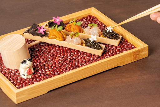 The decadent Monaka, presented alongside an adorable cat figurine, comes with caviar, botan ebi, uni, truffle, and ankimo (Credit: Jiin Omakase)