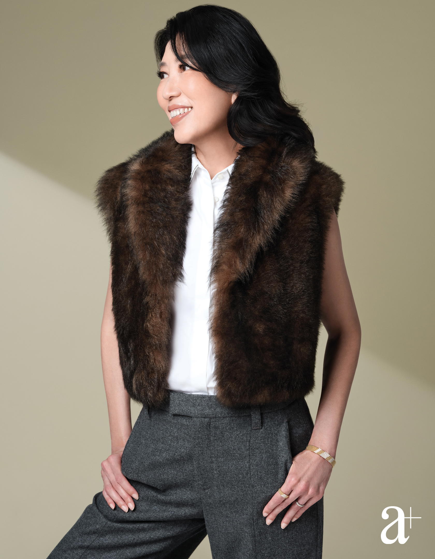 Perlée bracelet and rings in yellow gold with diamonds, all from Van Cleef & Arpels. Cotton shirt, shearling vest, and wool trousers, all from Brunello Cucinelli (Credit: Wee Khim)