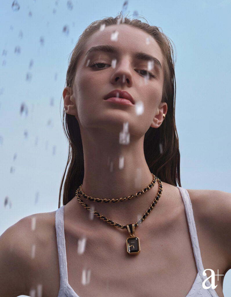 Premiere Iconic chain necklace watch in steel coated yellow gold, and jersey swimsuit, both from Chanel (Credit: Stefan Khoo)